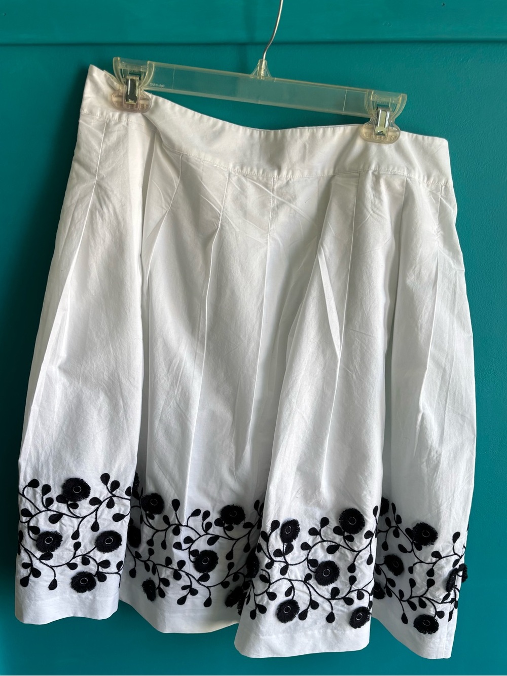 White Skirt with Navy Floral Embroidery/Decoration.